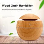 Wood grain humidifier on a wooden surface with green leaves