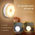 Round night light with warm glow on a brown background, featuring text about its features.