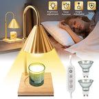 Gold table lamp with candle on a wooden base, control panel, and additional lamp parts in a bedroom setting.