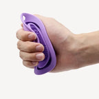 Hand using a purple silicone grip tool on a white background
