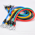Set of colorful resistance bands with metal hooks on a white background