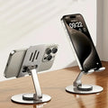 Two smartphone stands holding smartphones on a wooden surface with a blurred background