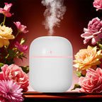 White humidifier with pink light surrounded by flowers on a dark background