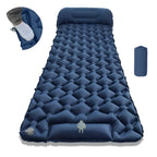 Blue inflatable sleeping pad with accessories on a white background
