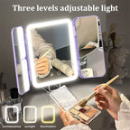 Lighted makeup mirror with three adjustable light levels on a table.