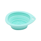Collapsible silicone strainer in light blue on a white background