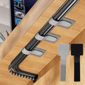 Metal U-shaped tool with adhesive strips on a wooden surface