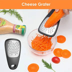 Cheese grater being used to shred a carrot with a bowl of shredded carrots on a white background.