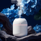 White humidifier emitting mist with blue flowers in the background