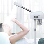 Woman using a white electronic device on a stand in a bright room