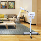 White spray device on a stand in a living room setting with a couch and coffee table.