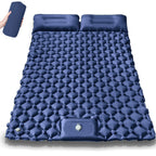 Blue inflatable camping mattress with two pillows on a white background