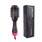 One-Step hair dryer and styler with pink accents next to its packaging on a white background