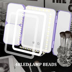 Portable LED light with 48 LED lamp beads on a surface with makeup brushes and a magazine.