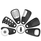 Set of black kitchen tools including a grater, peeler, and other attachments on a white background.