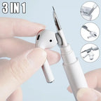 3-in-1 pen with different tips held by a hand against a light blue background