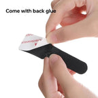Black strap with adhesive backing held by a hand against a white background