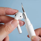 White pen with a small object resembling an airpuff device held by a hand against a light blue background