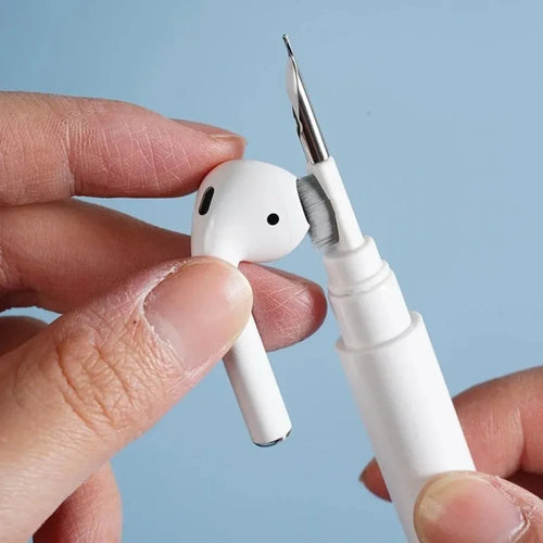 White pen with a small object resembling an airpuff device held by a hand against a light blue background